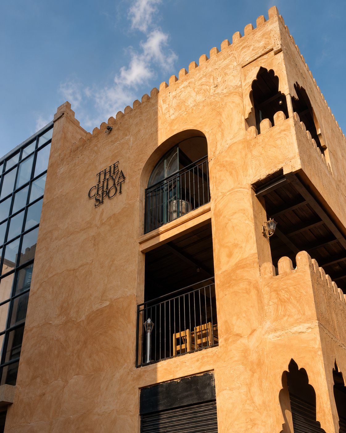 The Chiya Spot exterior with curved clay walls and arched windows