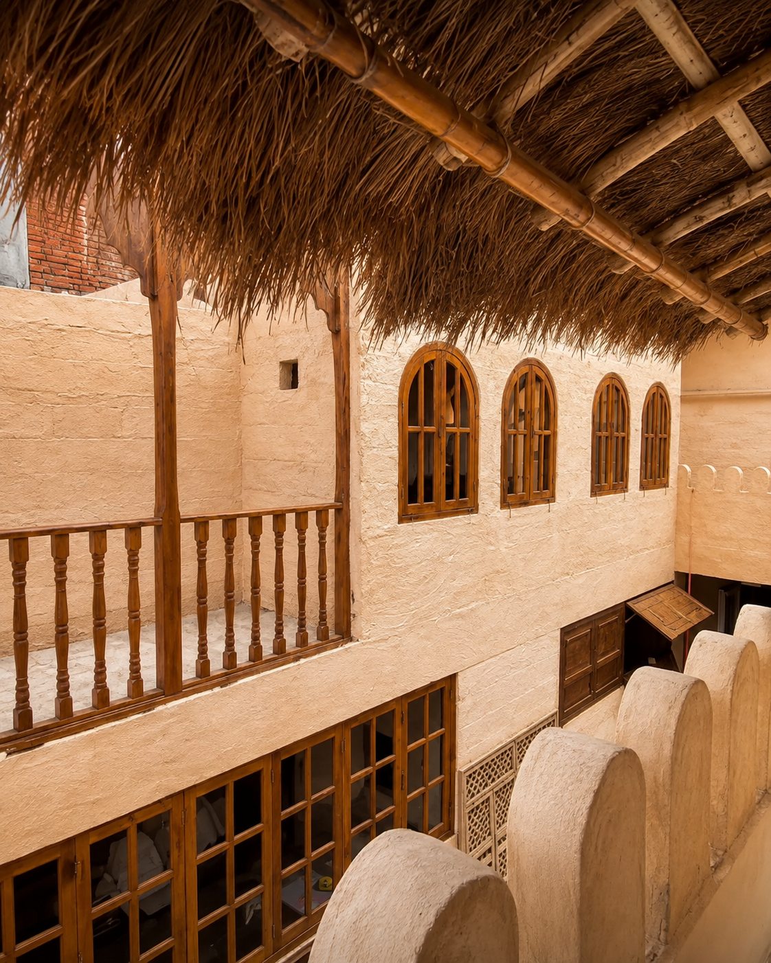 Thatched roof and carved timber arches at The Chiya Spot