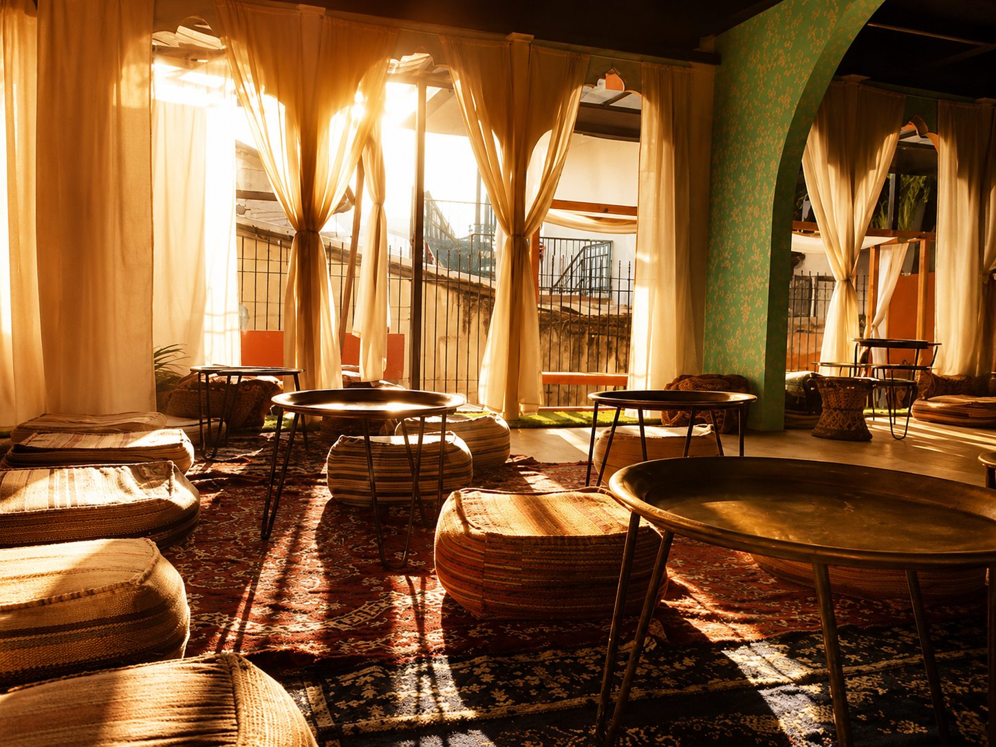 Golden afternoon light across low seating and patterned rugs